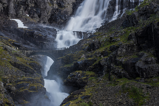 Trollstigen Road In Norway With Stone Bridge Waterfall And Dramatic Cliffs. Scenic Norwegian Destinations.