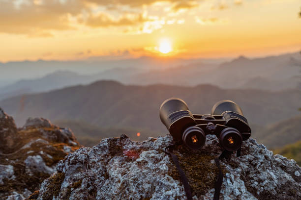 istock binoculars on top of rock mountain at sunset 1510003525