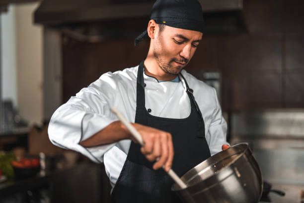 istock Good Looking Male Chef Mixing Ingredients 1510005100