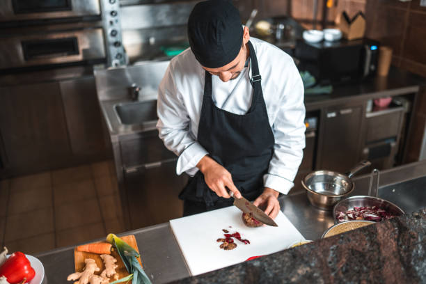 istock Asian Chef Focuses On Perfect Cuts 1510005108