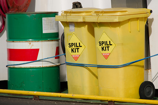 Spill kit yellow wheelie bin for health and safety of chemical, oil, diesel or petrol pollution leak UK