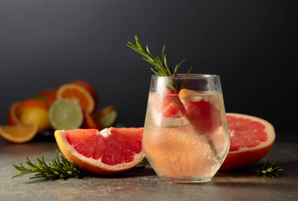 istock Cocktail gin tonic with ice, rosemary, and grapefruit on a stone table. 1510091780