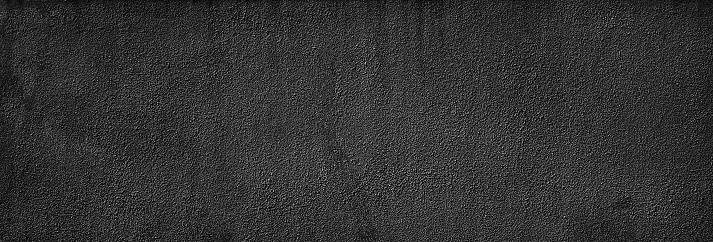 Black white grunge texture background. Concrete wall with rough plaster. Close-up. Banner. Wide. Panoramic.