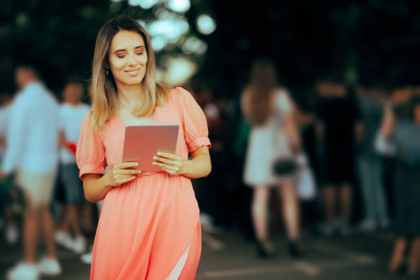 Beautiful Weeding Planner Holding a Tablet Pc Outside