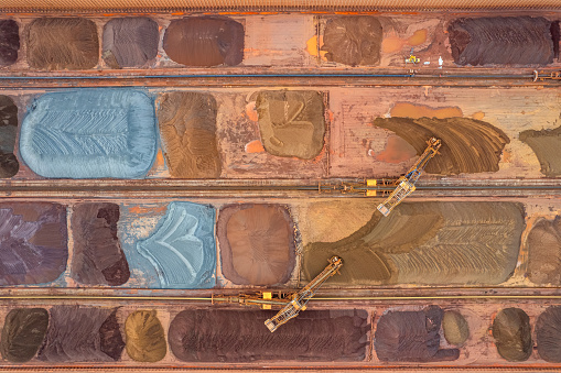 Vertical aerial view of pier with stacked ore raw materials