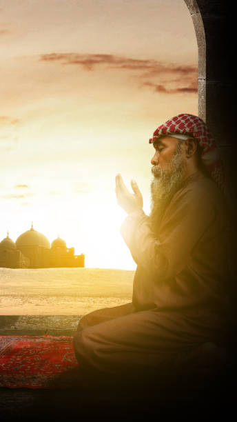 istock Muslim man with a beard wearing keffiyeh with agal in praying while raised hands 1510161140