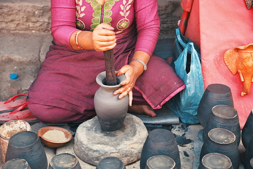 Midsection of professional potter making bowl in pottery workshop - Kathmandu, Nepal