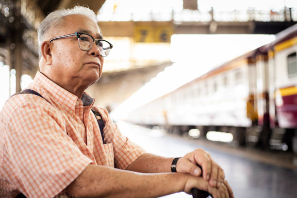 istock Lonely Asian tourist eldery man with backpack at train station. 1510243328