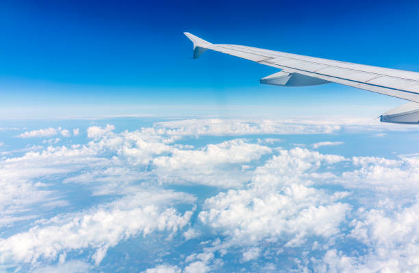 istock View from the airplane window at a beautiful cloudy sky and the airplane wing 1510272275