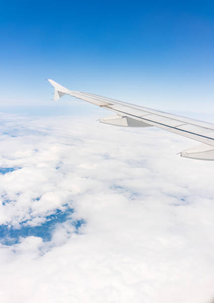 istock View from the airplane window at a beautiful cloudy sky and the airplane wing 1510272282