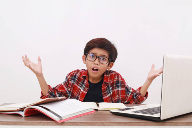istock Confused asian student studying on the desk with asking hand gesture. Isolated on white 1510285686