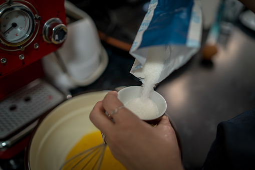 Patisserie making pastry pouring sugar