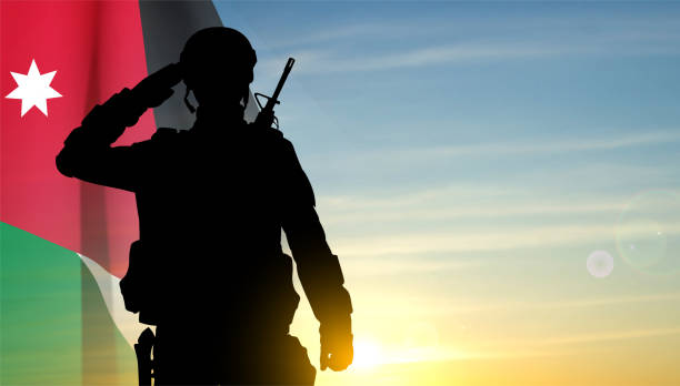 istock Silhouette of a saluting soldier with Jordan flag 1510394350
