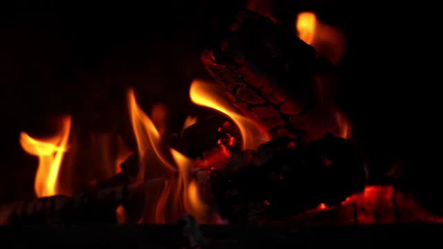 Cinematic shot of burning fire depicting playful dances of flames.