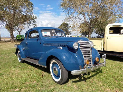 Chascomus, Argentina – April 16, 2023: An old blue 1938 Chevrolet Chevy Master business coupe by General Motors on the lawn
