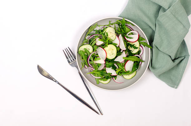 green salad with arugula, radish and cucumber. Fresh vegetarian vegetable salad. Healthy vegan food.