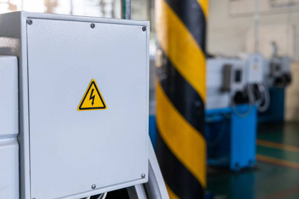 High voltage sign on machine at industrial factory.