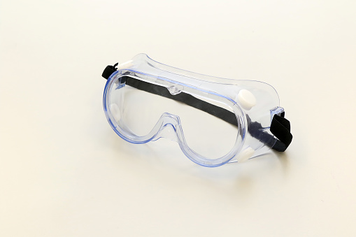 Safety goggles or safety glasses for prevent contaminants from getting in the eyes. Personal protective equipment guarding against impact hazard, dust, spark and glare.