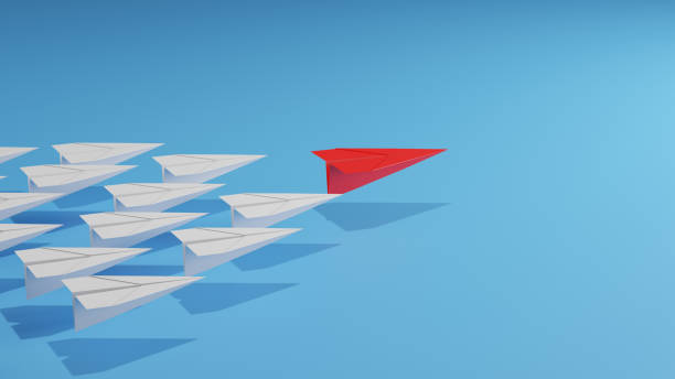 istock Leadership concept with red paper plane leading among white on blue background. 1510500269