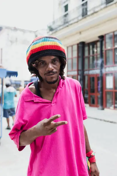 African American man with dreadlocks and a purple T-shirt in Latin America, rastafarian or rastaman caribbean people