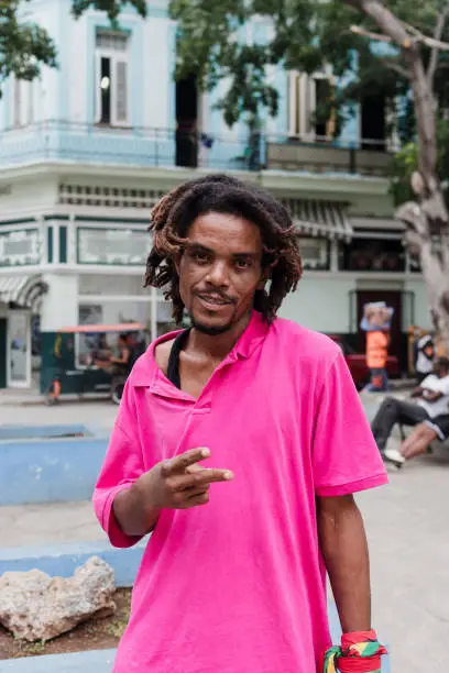 African American man with dreadlocks and a purple T-shirt in Latin America, rastafarian or rastaman caribbean people