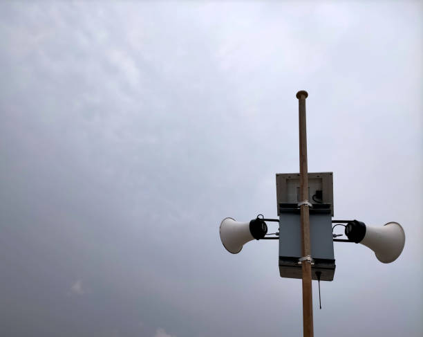 mast with two white speakers outdoors. (news concept, novelty, talk)