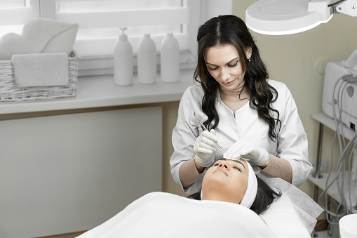 The photo shows the moments and relaxation that accompany a deep cleansing of the skin of the face, creating an unsurpassed experience of self-care and maintaining skin health at the procedure at the beautician. High quality photo