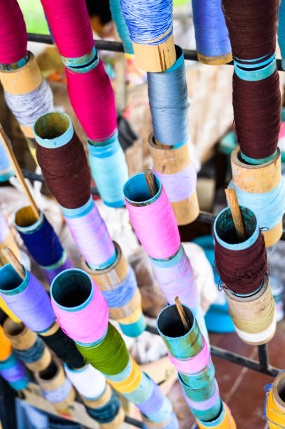 istock Multi coloured yarn spools are prepared for Lanna style traditional umbrella making 1510566060