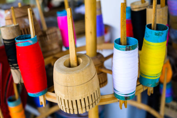 istock Multi coloured yarn spools are prepared for Lanna style traditional umbrella making 1510566427