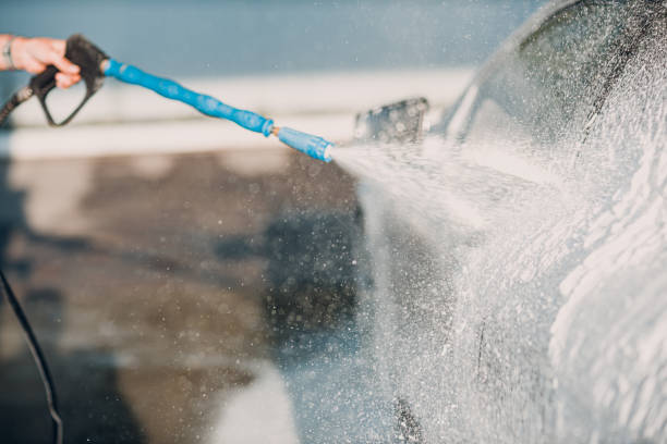 istock Worker washing car at self-service car wash 1510607686