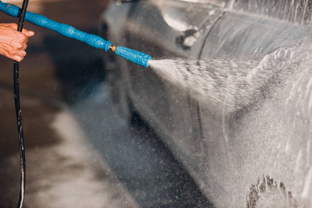 istock Worker washing car at self-service car wash 1510607689