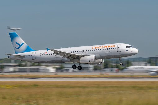 Munich, Germany - June 29. 2023 : Freebird Airlines Airbus A320-232 with the aircraft registration TC-FHG during landing to the southern runway 26L of the Munich Airport MUC EDDM