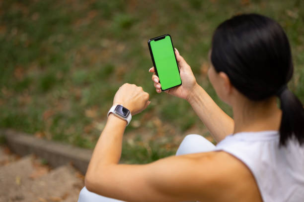 istock Sportswoman checking her progress on mobile app while having a break in the park. 1510623448