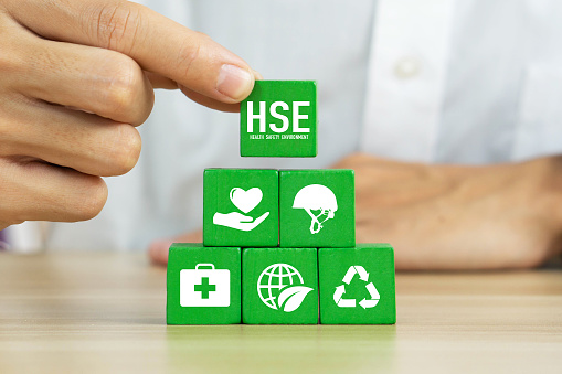 HSE - health safety environment concept.Hand holding wooden cube block with HSE icon.Work safety Regulation rules business.Safe and standardized industry.