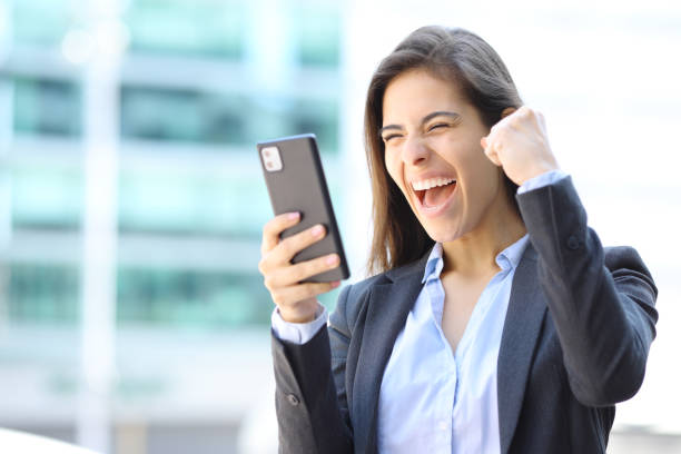 istock Excited executive celebrating checking cell phone 1510668132