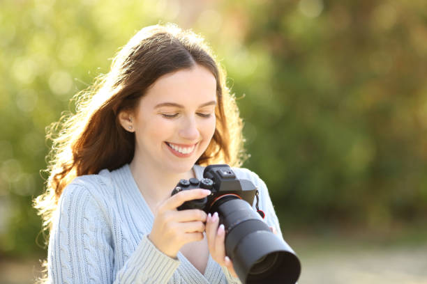 istock Happy photographer checking pictures on camera 1510673467