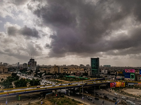 The picture taken just before the thunderstorm, picture describe the urban busy life of metropoliton city, bridges, buidlings and the roads clearly showing the heavy civic side of the city, karachi-pakistan-June,17-2022