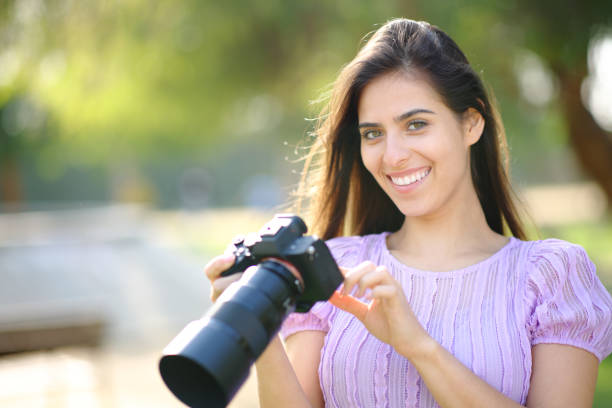 istock Happy photographer checking camera looking at you 1510695933