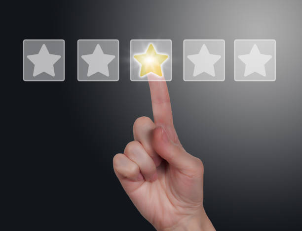 istock Woman's hand touching five-star rating icons with index finger on dark gradient background 1510701893