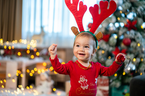 Portrait of happy little girl during Christmas playing at home