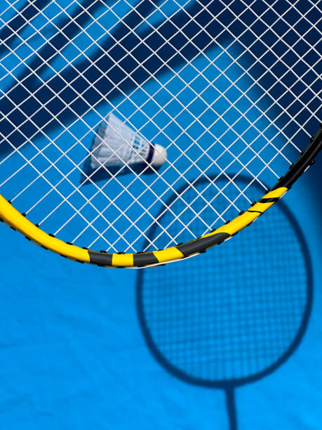 istock Rackets and badminton shuttlecock on a bright sunny day. View from above, drawing shadows 1510720756
