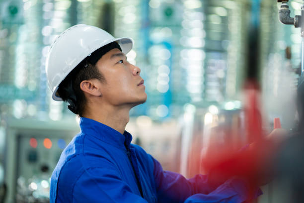 Asian technician engineer maintenance  Drinking water pipe and pressure tank .