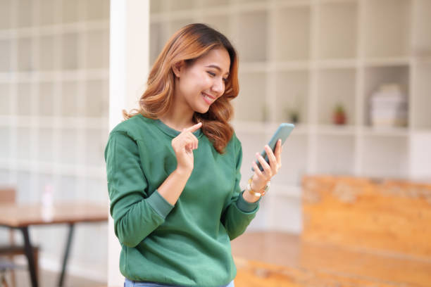 istock Beautiful Asian woman using smartphone to check work contact customers, answer chats, complete transactions and use social media application. 1510746562