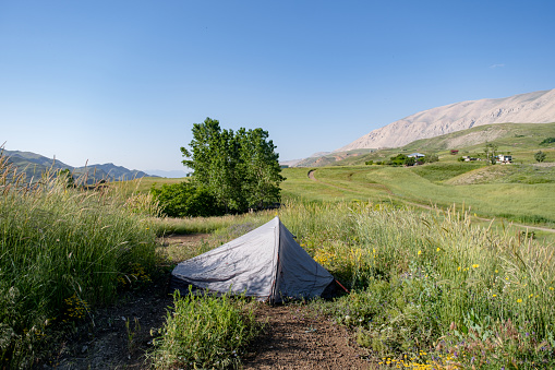 Mediterranean region mountains at high altitudes. Tent camping. Open air. Green areas plateau. Landscape camping photo