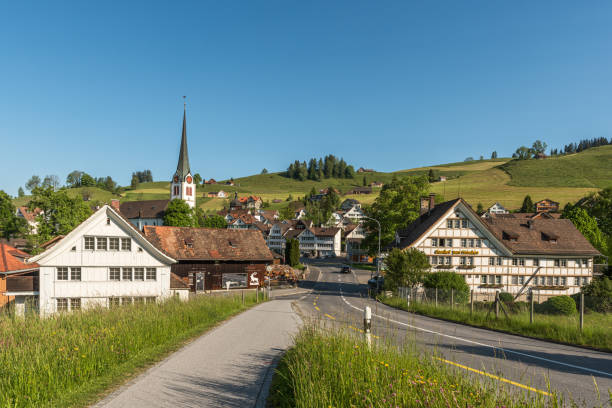 The village of Gais with traditional Appenzell houses and church, Gais, Appenzell Ausserrhoden, Switzerland Gais, Appenzell Ausserrhoden, Switzerland - May 31, 2013. Gais is a small village in the Swiss canton of Appenzell Ausserrhoden and is located 15 km south of the city of St. Gallen. The village center is famous for its typical Appenzell wooden houses with curved gables. appenzell ausserrhoden stock pictures, royalty-free photos & images