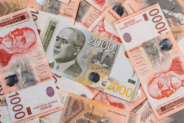 Heap of Serbian Dinar Banknotes Pile of Serbian dinar banknotes. Single 2000 dinars bill laid above heap of 1000-dinars bills. dinar stock pictures, royalty-free photos & images