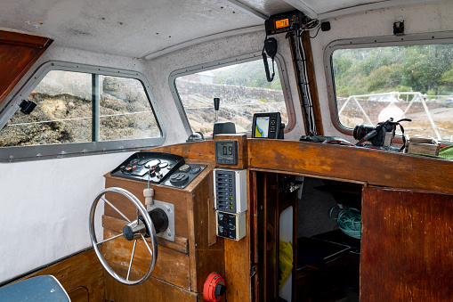 The inside of a tourboat cockpit while docked in Torridon, Scotland.