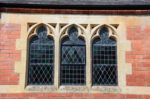 Paris, France: Antique Windows with Red Stained Glass Close-Up