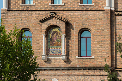 Brick church with christian icon on a wall