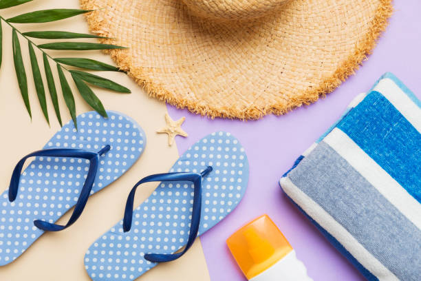 istock Beach accessories straw hat and seashell on colored table. Summer concept background 1510864338
